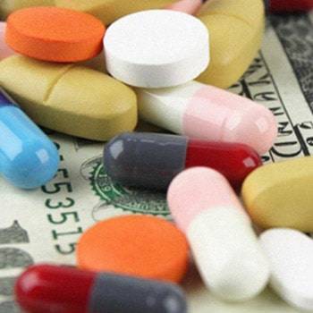 a pile of pills on a dollar bill