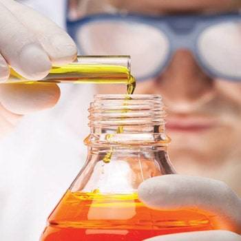 a person pouring liquid into a bottle